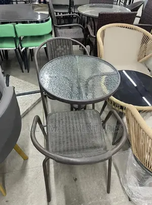 Modern Round Glass-Top Bistro Table With Brown Wicker Chair