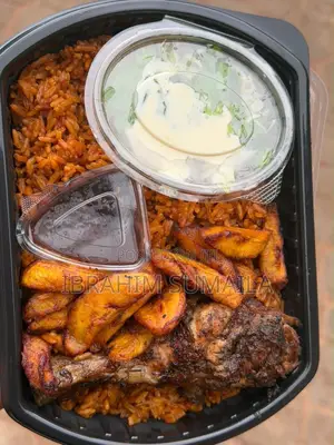 Assorted Jollof Rice With Spicy Wings and Served Fried Plantain