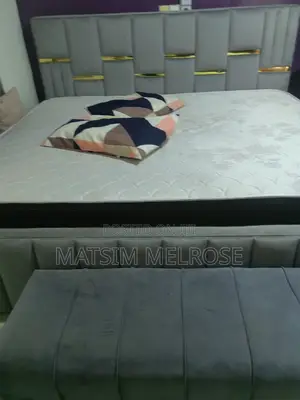 Bed With Two Dressers and a Sofa