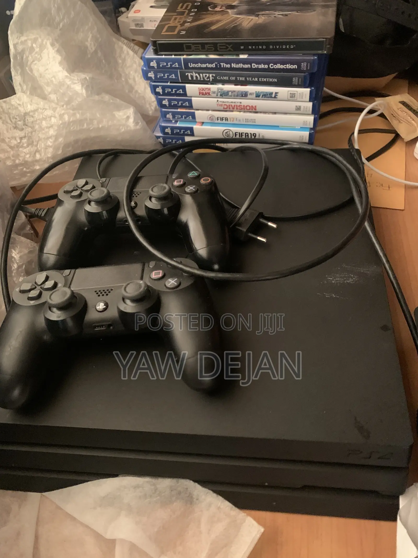 PS4 Pro (1TB) With 2 Controllers and 5 Games CDs and FC26 Installed)