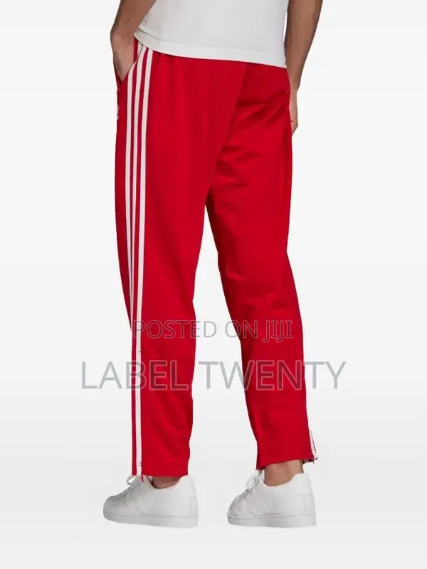 Red Tracksuit With Three White Stripes