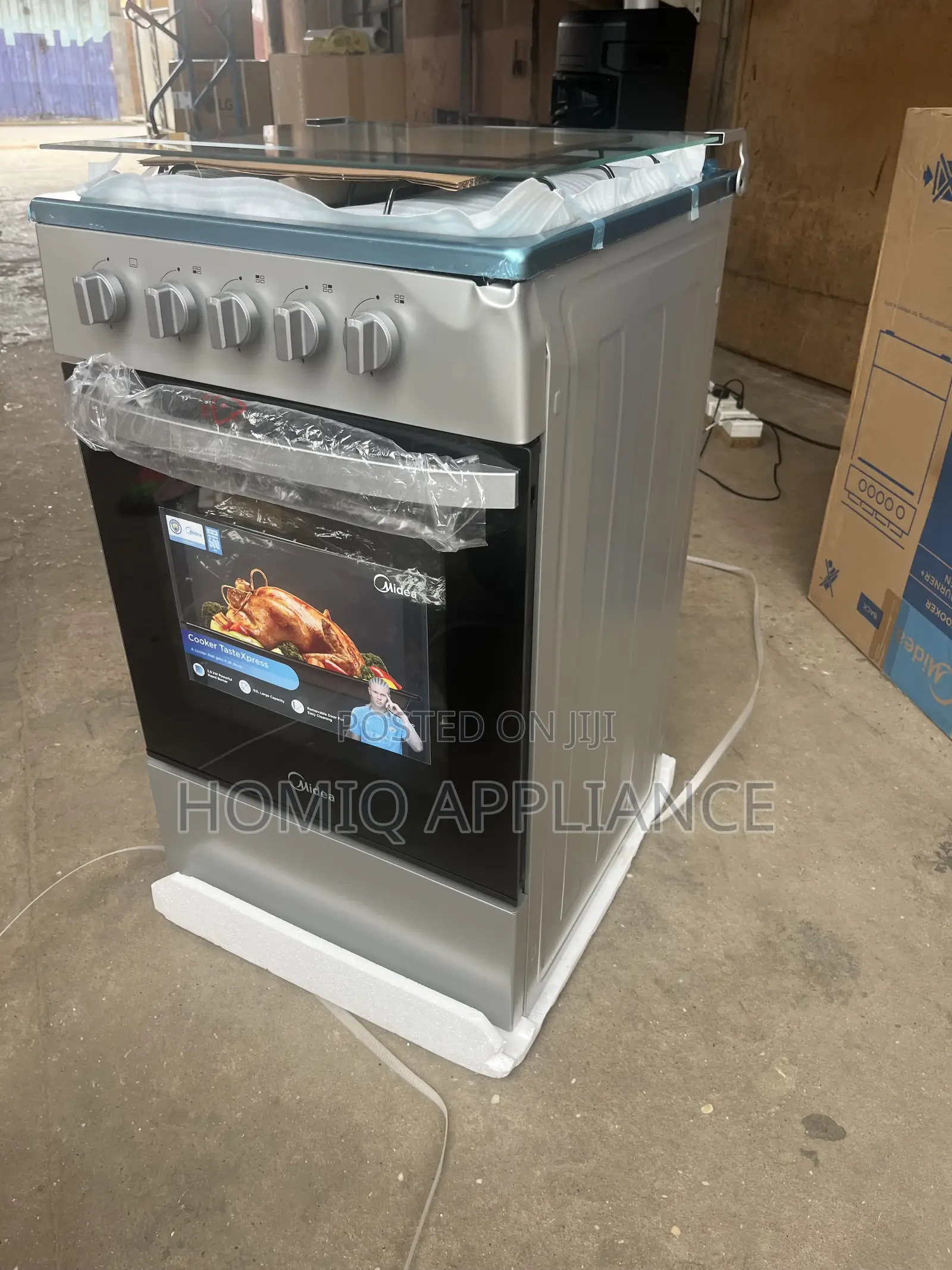 Midea 50×50 4 Burner Gas Cooker| Glass Lid, Silver Available