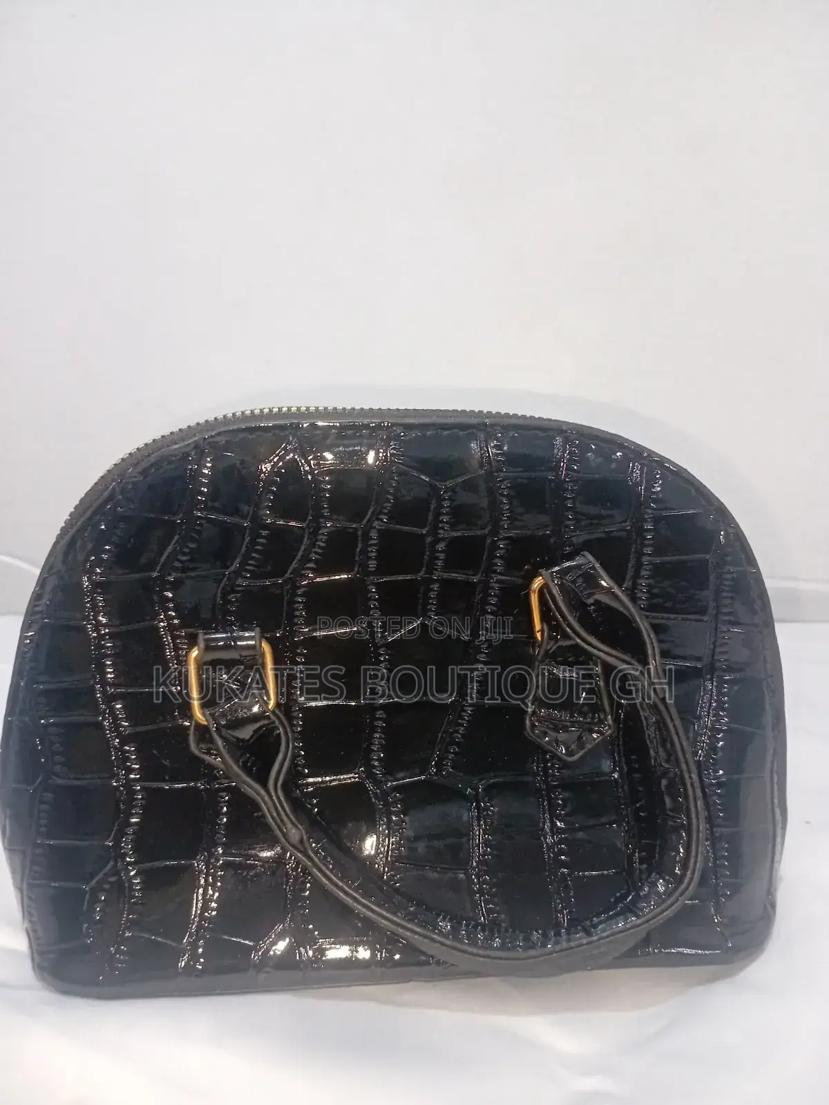 A Black Patent (Glossy) Crocodile-Embossed Handbag.
