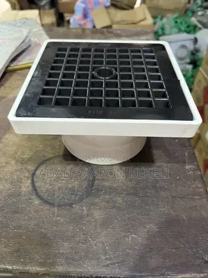 Heavy-Duty PVC Floor Drain With Black Grid Strainer Cover