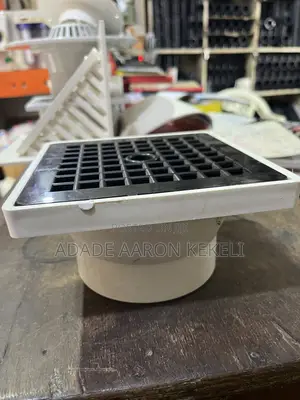 Heavy-Duty PVC Floor Drain With Black Grid Strainer Cover