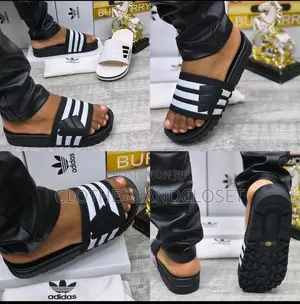Adidas Slides,three-Stripe Bandage Upper and a Thick Textured Outsole.