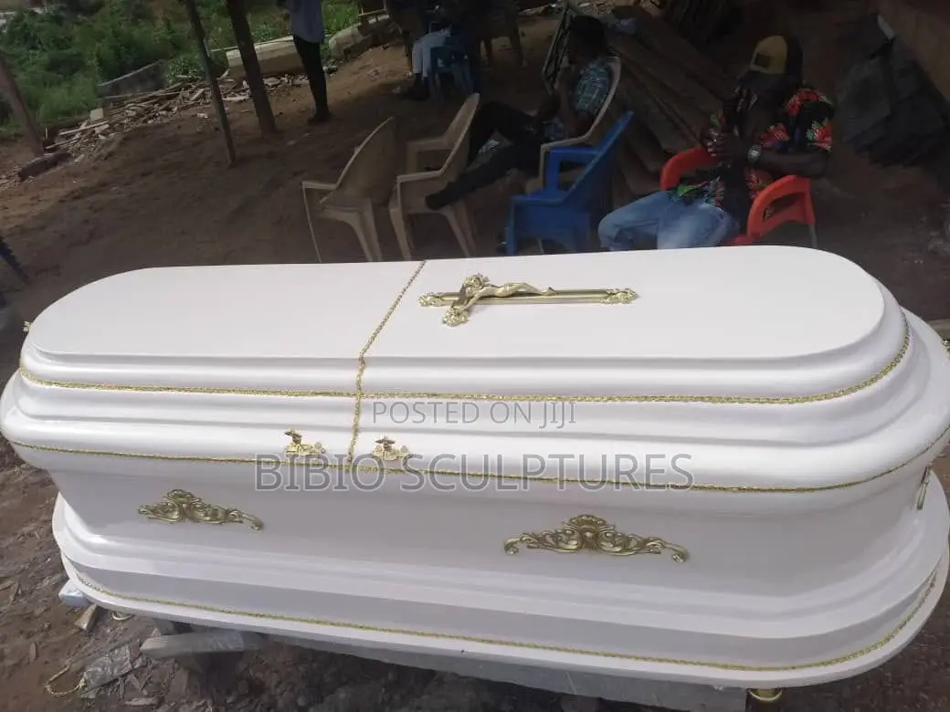 White Oval-Top Casket With Gold Trim