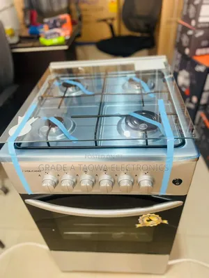 A Glass Top Lid Volcano 50-50 Four Burners Gas Cooker