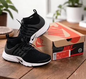 Pair of Black and White Nike Air Presto Ultra Flyknit Sneakers