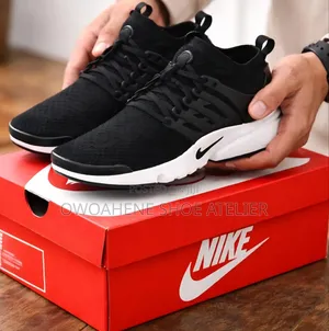 Pair of Black and White Nike Air Presto Ultra Flyknit Sneakers