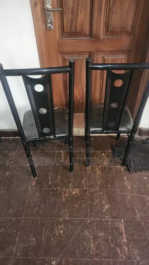 Table and 4 Chairs. (Small Chip on Side of Table)