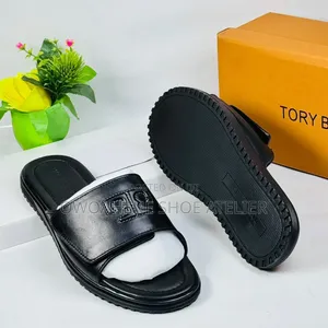 A Pair of Tory Burch Double T Sport Slides in Black