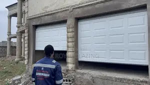 White Modern Remote Double Garage Door Well Installed
