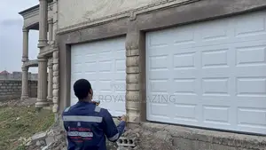 White Modern Remote Double Garage Door Well Installed