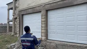 White Modern Remote Double Garage Door Well Installed
