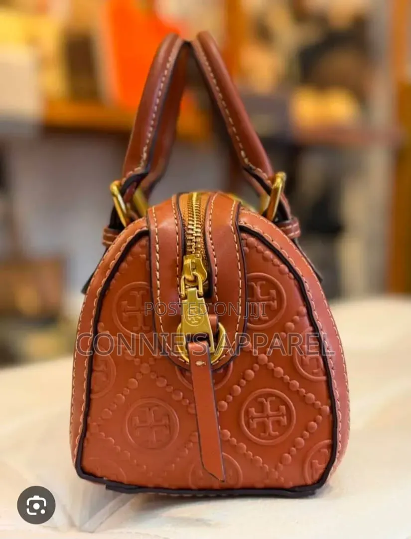 Embossed Monogram Pattern and Buckled Top Handle