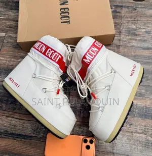 White Moon Boot Snow Boots a Bold Red Logo Strap Acros