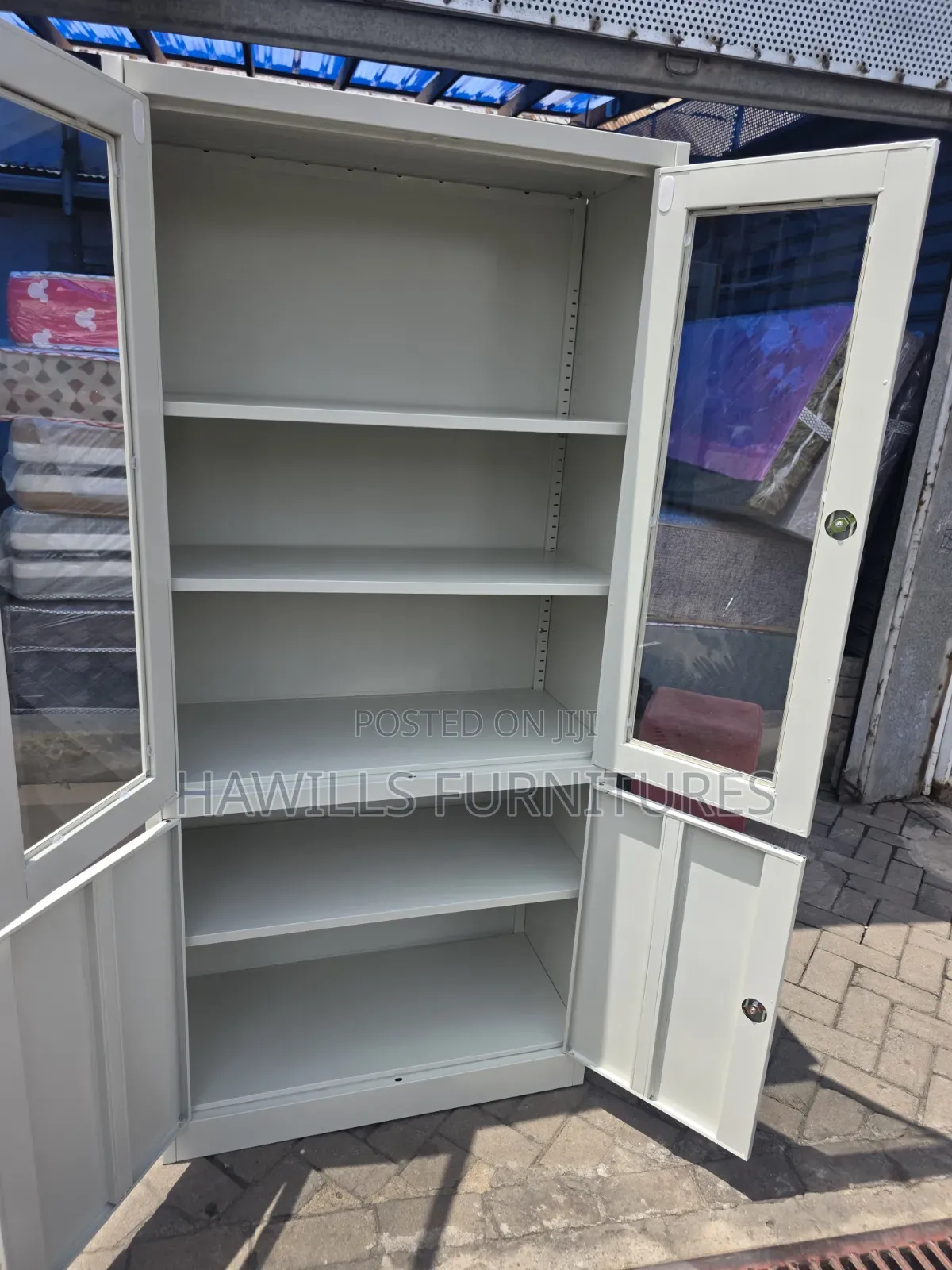 Metal Cabinet With Glass Top Doors and Solid Bottom Doors.