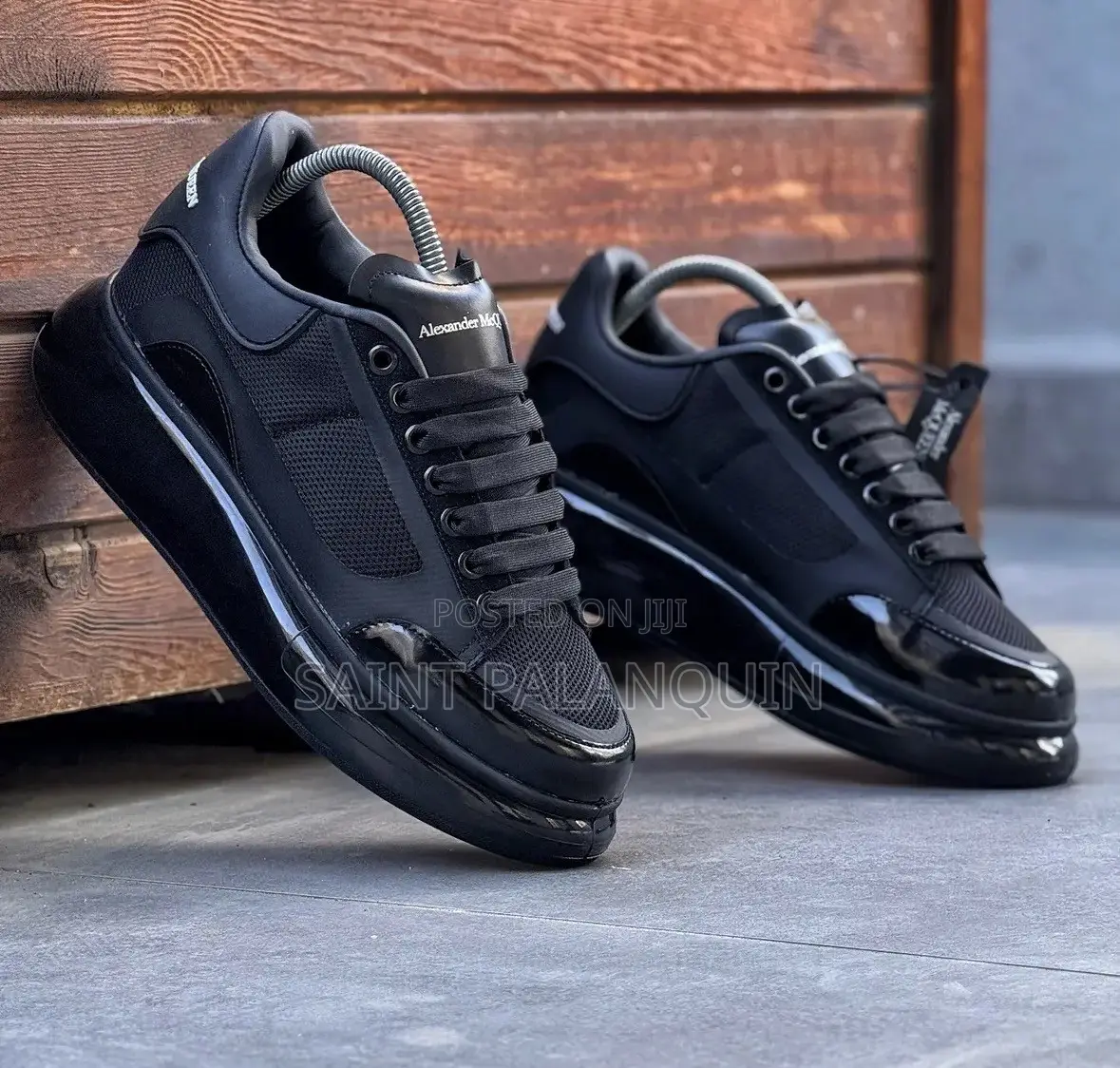 Black McQueen Low-Top Sneaker Wih a Thick Ridged Sole and a Mesh Upper