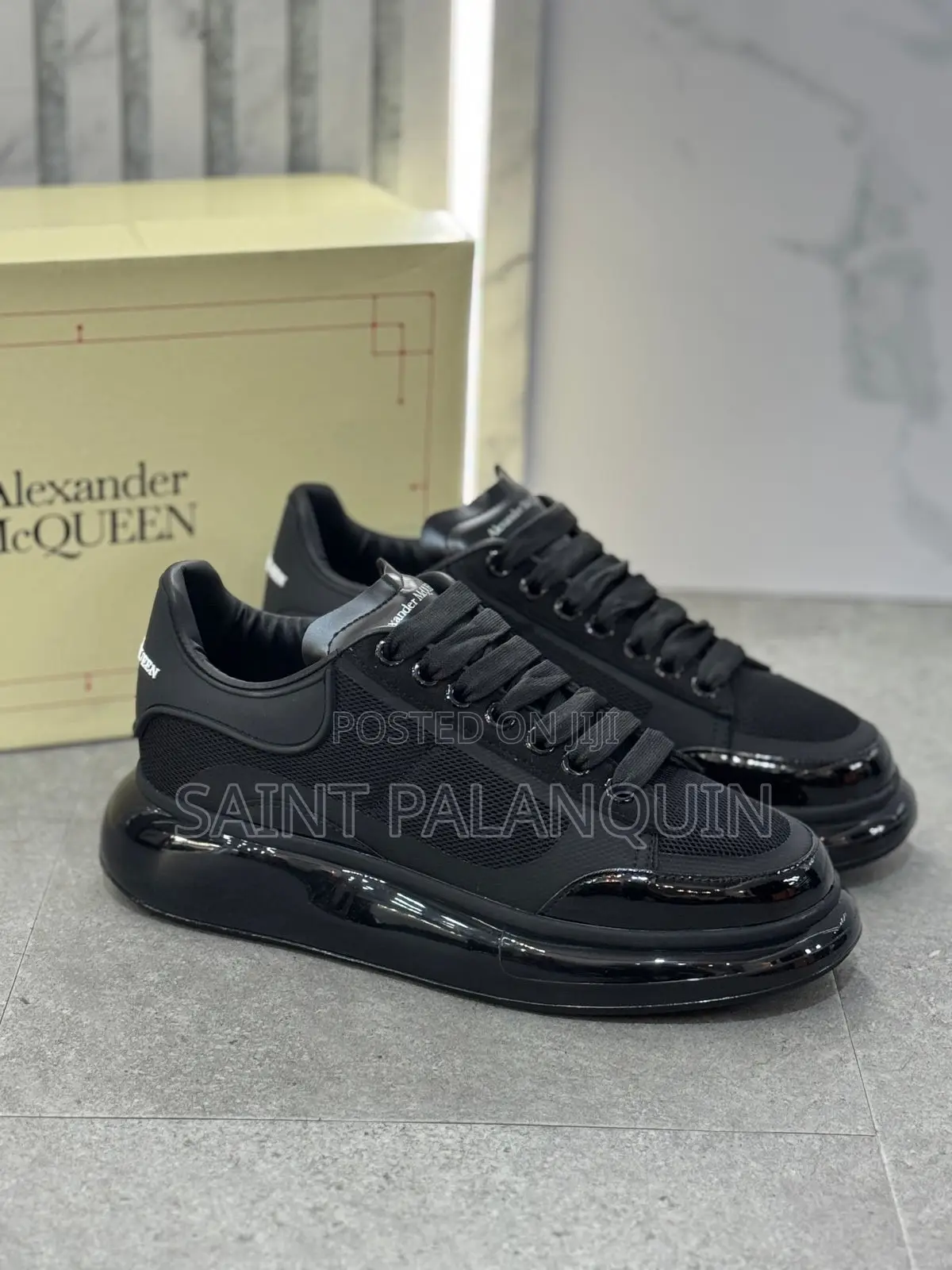 Black McQueen Low-Top Sneaker Wih a Thick Ridged Sole and a Mesh Upper