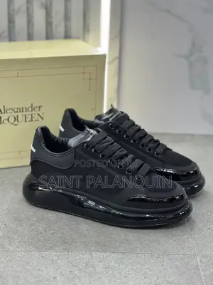 Black McQueen Low-Top Sneaker Wih a Thick Ridged Sole and a Mesh Upper