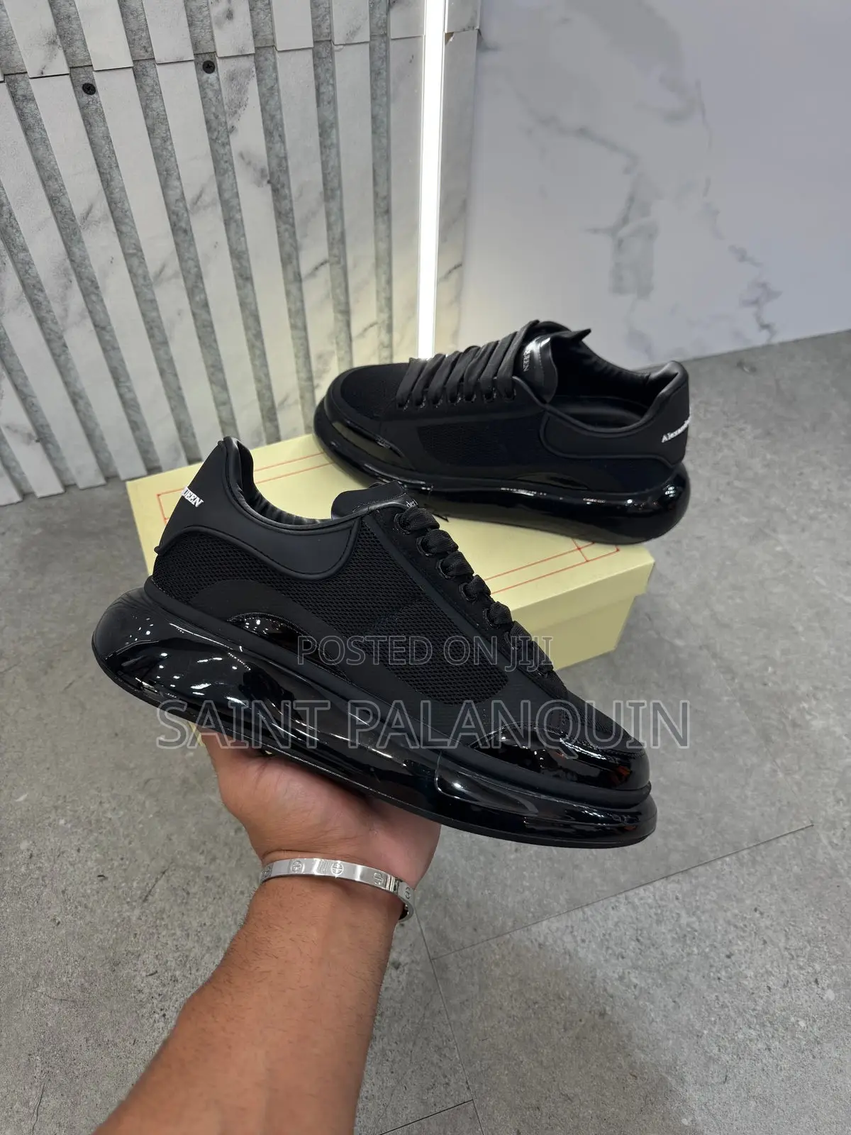 Black McQueen Low-Top Sneaker Wih a Thick Ridged Sole and a Mesh Upper