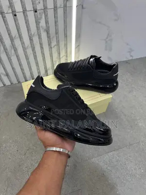 Black McQueen Low-Top Sneaker Wih a Thick Ridged Sole and a Mesh Upper