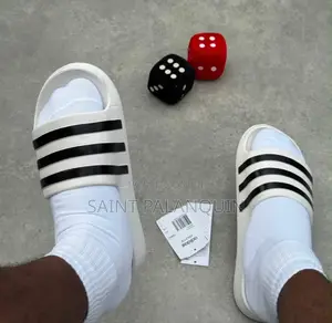 These Are the White Adidas Slide Sandals Three Distinct Black Stripes