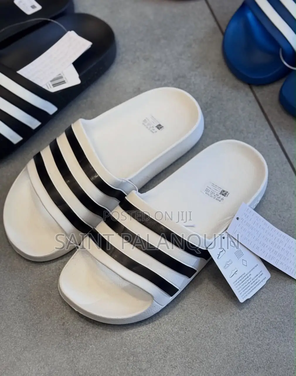 These Are the White Adidas Slide Sandals Three Distinct Black Stripes