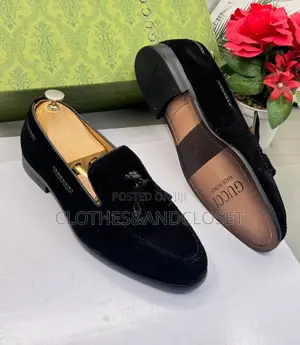 A Pair of Men's Black Suede Tassel Loafers