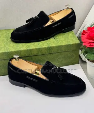 A Pair of Men's Black Suede Tassel Loafers