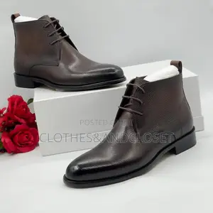 Dark Brown Leather Chukka Boots With Lace-Up Closures and Block Heels.