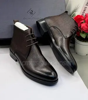 Dark Brown Leather Chukka Boots With Lace-Up Closures and Block Heels.