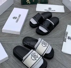 The Image Shows a Pair of Black and White Roberto Cavalli Slides