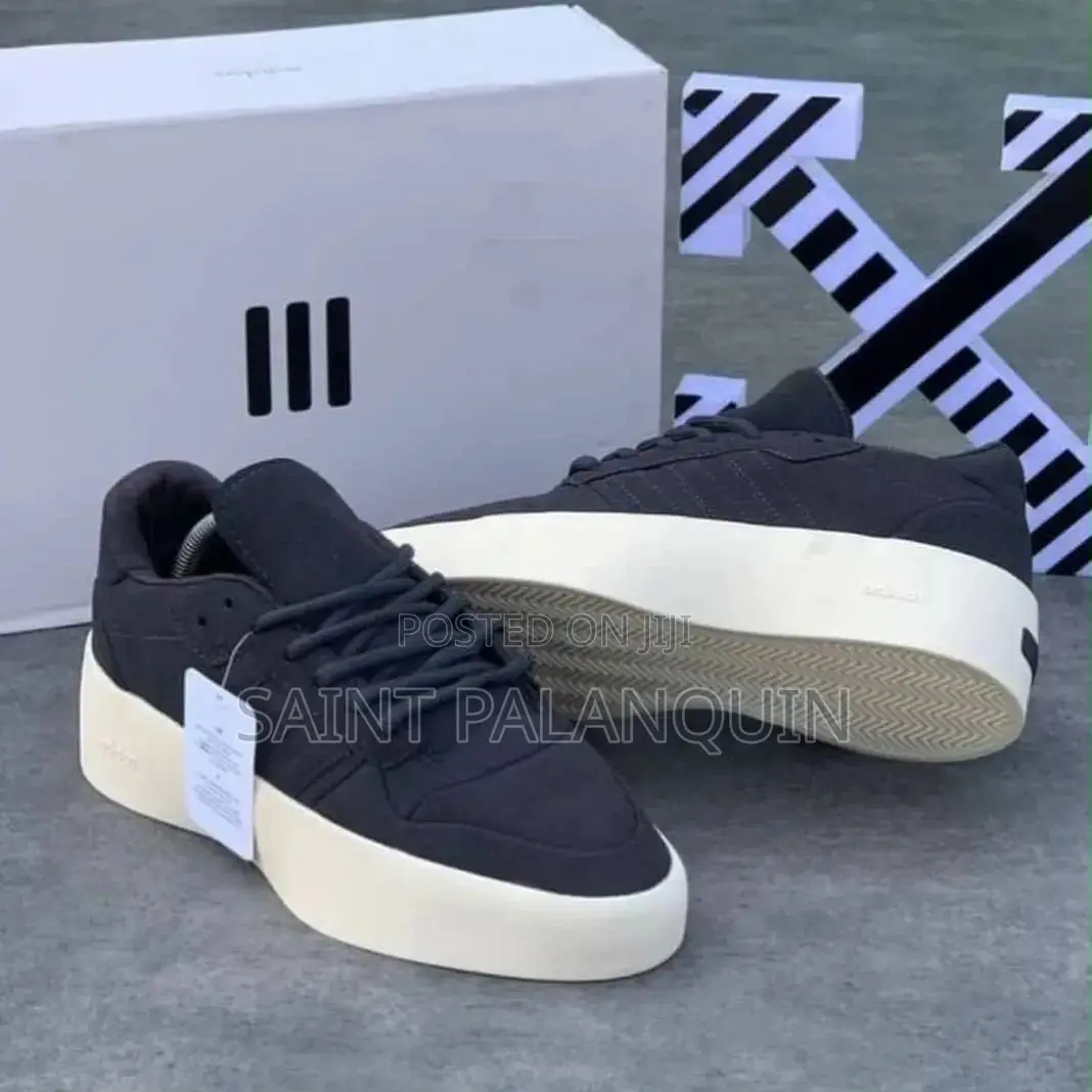 Apair of Black Adidas X Fear of God Athletics Sneakers