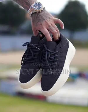 Apair of Black Adidas X Fear of God Athletics Sneakers