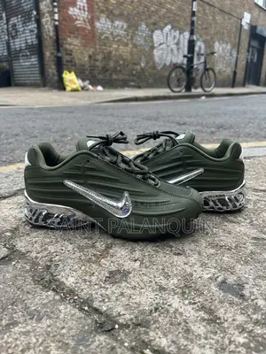 The Image Shows the Olive Green Nike NOCTA Glide Sneakers