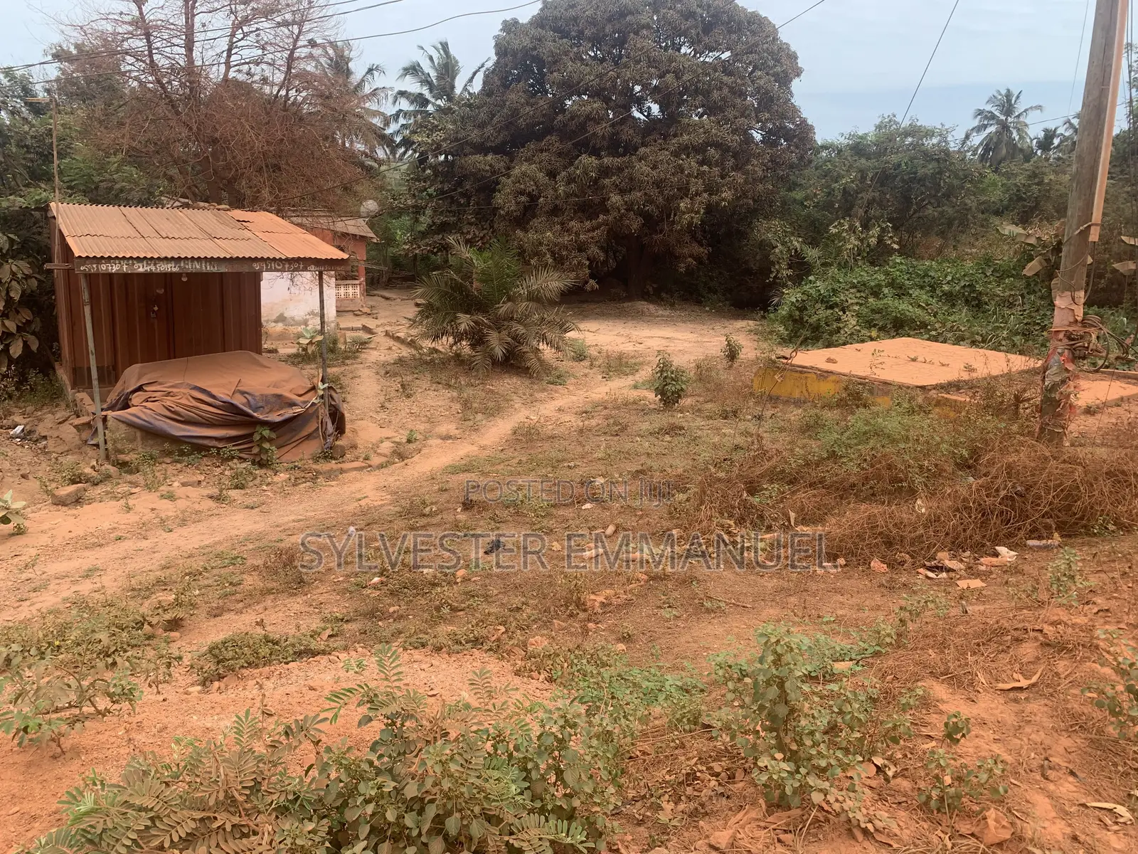 A Plot of Land (70/100 ) at Aplaku on a Roadside With a Building