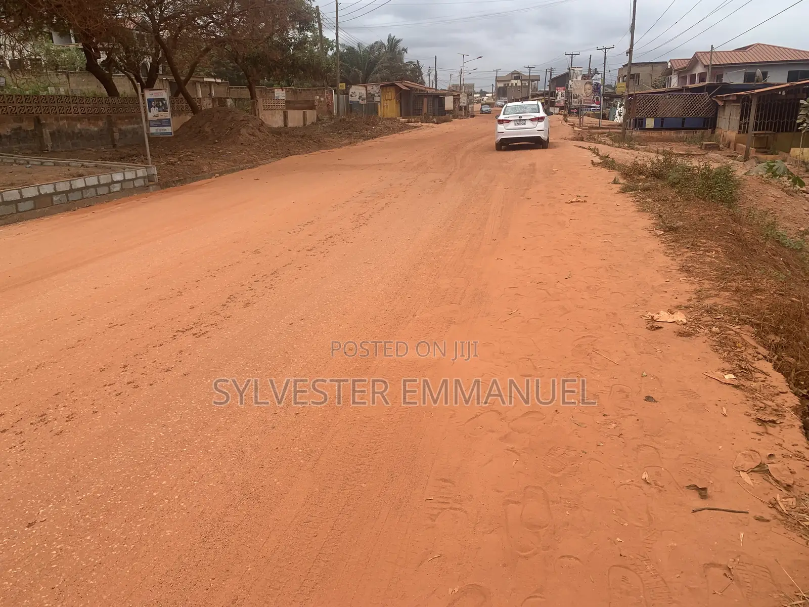A Plot of Land (70/100 ) at Aplaku on a Roadside With a Building