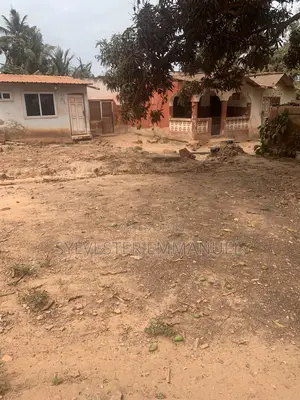 A Plot of Land (70/100 ) at Aplaku on a Roadside With a Building