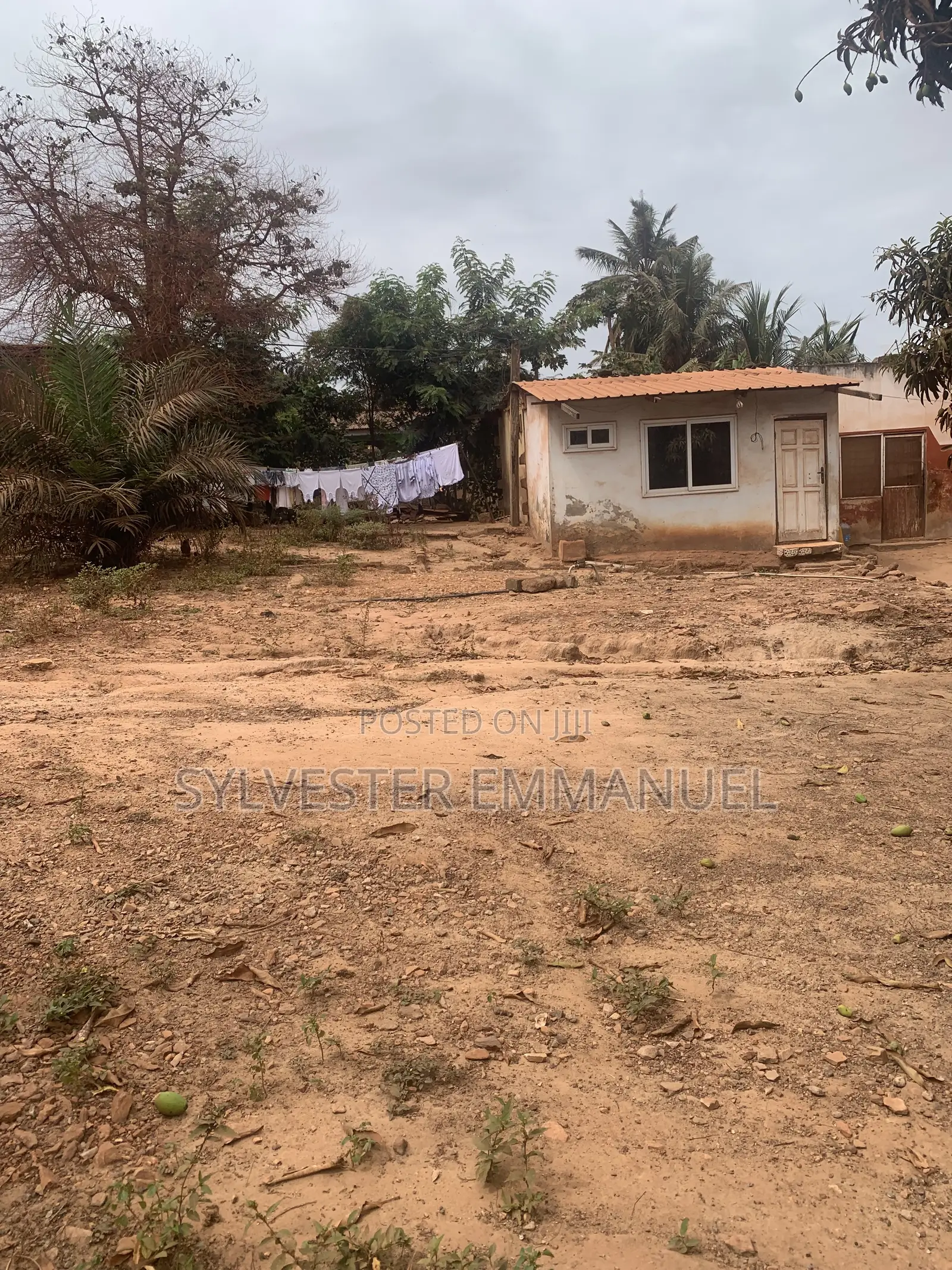A Plot of Land (70/100 ) at Aplaku on a Roadside With a Building