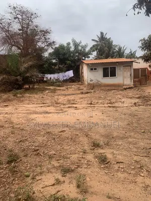 A Plot of Land (70/100 ) at Aplaku on a Roadside With a Building
