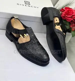 A Pair of Black Embossed Leather Monk-Strap Shoe-Sandals