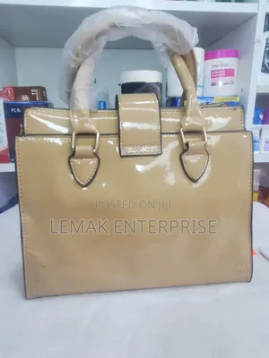 Beige Embossed Patent Leather Top-Handle Handbag With Scarf.