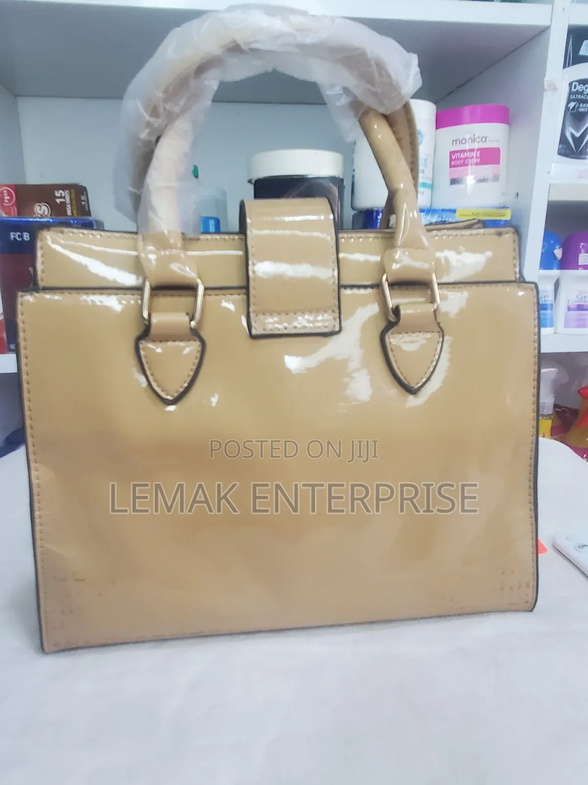 Beige Embossed Patent Leather Top-Handle Handbag With Scarf.