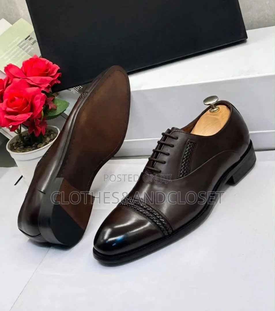 Polished Dark Brown Leather Oxfords Feature a Braided Cap-Toe Detail.