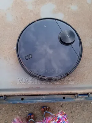 The Image Shows a Wyze Robot Vacuum, a Smart Automated Cleaning Device
