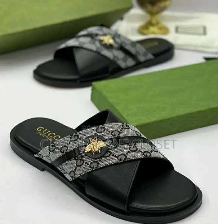 Stylish Black Leather Slides Feature a Striking Cross-Strap Desig