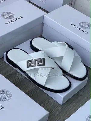 Stylish Black Leather Slides Feature a Striking Cross-Strap Desig