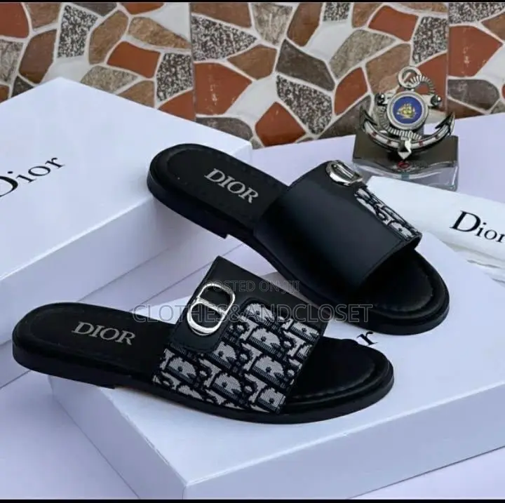 Stylish Black Leather Slides Feature a Striking Cross-Strap Desig
